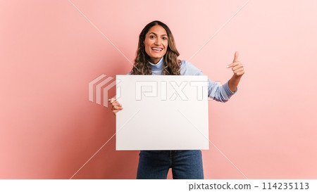Woman holding a blank panel and pointing around Woman holding a blank panel and pointing around 114235113