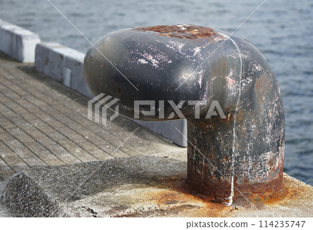 Rusted mooring post on the quay Rusted mooring post on the quay 114235747