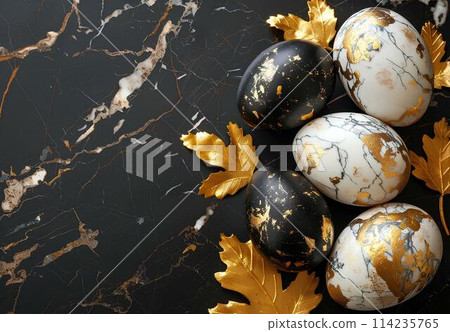 Golden easter eggs with gold leaves on black marble background. Top view with copy space. Happy Easter concept Golden easter eggs with gold leaves on black marble background. Top view with copy space. Happy Easter concept 114235765