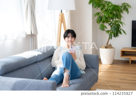 在房間裡操作智能手機的女人 114235827