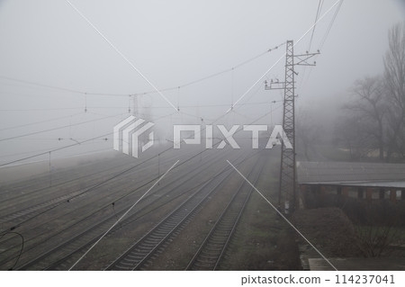 Poor Visibility Conditions. Fog Rails on Railway, leaving into Foggy distance beyond the horizon. 114237041