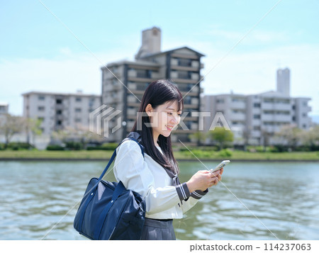 High school girl using smartphone High school girl using smartphone 114237063