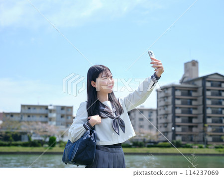 High school girl using smartphone High school girl using smartphone 114237069