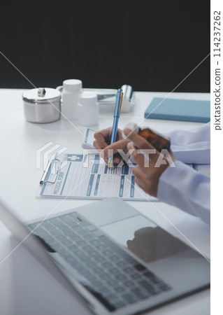 Cropped view of doctor in white coat holding bottle medication, prescribing pills to sick patient via online consultation. Family therapist recommend quality medicines. Healthcare, treatment concept 114237262
