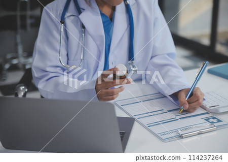 Cropped view of doctor in white coat holding bottle medication, prescribing pills to sick patient via online consultation. Family therapist recommend quality medicines. Healthcare, treatment concept Cropped view of doctor in white coat holding bottle medication, prescribing pills to sick patient via online consultation. Family therapist recommend quality medicines. Healthcare, treatment concept 114237264