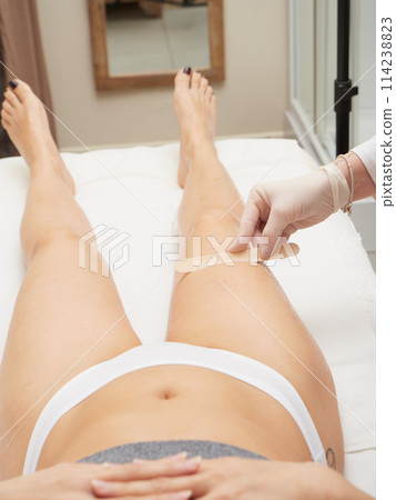 Beautician applying wax before Removing Hair Of Young Woman's body Beautician applying wax before Removing Hair Of Young Woman's body 114238823