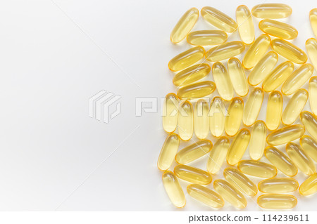 Pile of capsules Omega 3 on white background. Close-up, top view, copy space for your text. Pile of capsules Omega 3 on white background. Close-up, top view, copy space for your text. 114239611