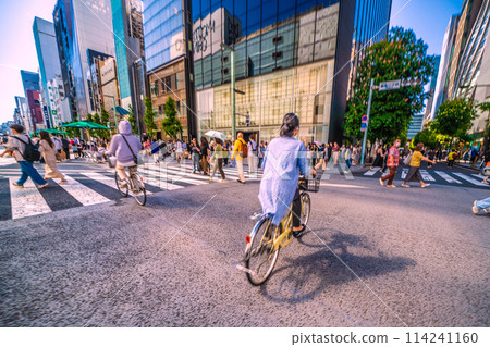 Tokyo cityscape in Japan: Bicycles (both driven by women) passing by... Ginza Hokoten... astonishing... = May 5th 114241160