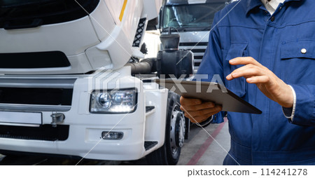 Serviceman with digital tablet on the background of the truck in the garage.. 114241278