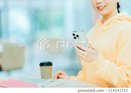 一名女大學生正在操作智慧型手機。 （零件模型）攝影合作：有明教育藝術專門學校 114241732