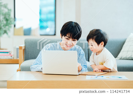 A boy who interferes with his mother who is working from home. 114241734