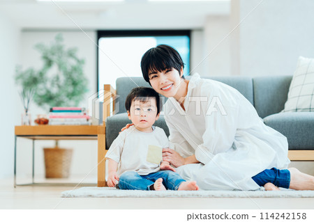 Parents and children cuddling in the living room Parents and children cuddling in the living room 114242158