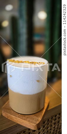 Fresh iced coffee in glass with frothy cream for your design, Food concept in style, copy space Fresh iced coffee in glass with frothy cream for your design, Food concept in style, copy space 114242329