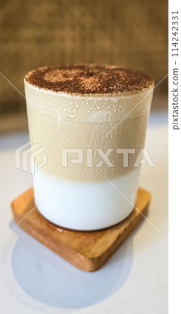 Fresh iced coffee in glass with frothy cream for your design, Food concept in style, copy space Fresh iced coffee in glass with frothy cream for your design, Food concept in style, copy space 114242331