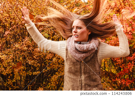 Woman walking in park during autumn 114243806