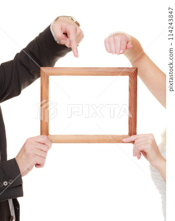 wedding couple pointing empty frame for photos. 114243847