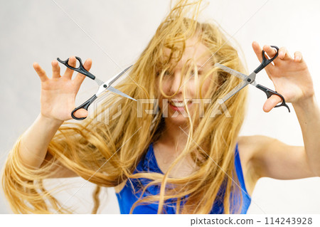 Girl with scissors for haircutting Girl with scissors for haircutting 114243928