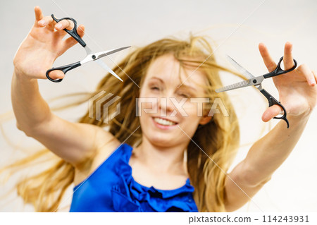 Girl with scissors for haircutting Girl with scissors for haircutting 114243931