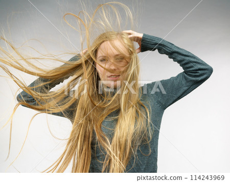 Girl with hair flying around her face 114243969