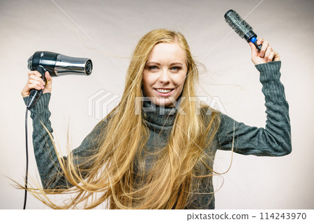 Girl holds hair accessories, styling hair 114243970