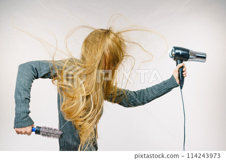Girl holds hair accessories, styling hair 114243973