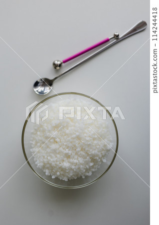 close-up of candle wax in granules on a light background 114244418