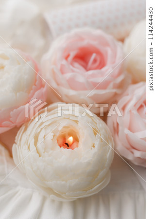 handmade candle in the shape of a flower on a light background, space for text handmade candle in the shape of a flower on a light background, space for text 114244430