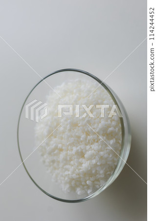 close-up of candle wax in granules on a light background close-up of candle wax in granules on a light background 114244452