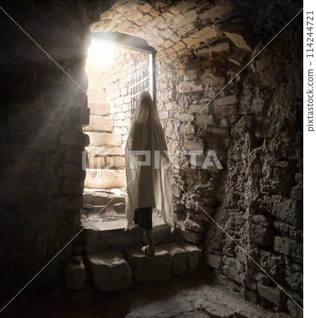 A person emerges from a dark dungeon A person emerges from a dark dungeon 114244721