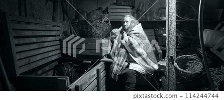 A woman hides in a cellar from shelling 114244744