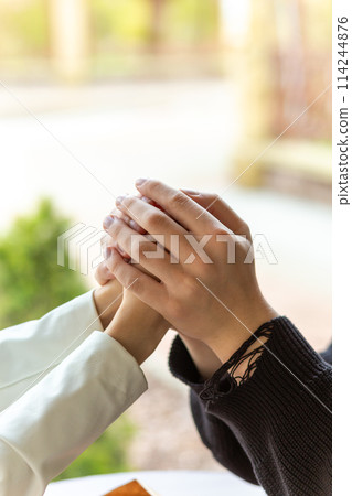 Couple enjoying a coffee holding hands. 114244876