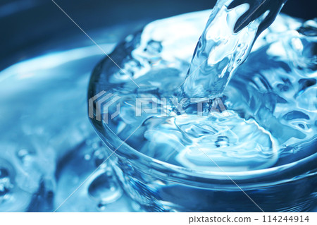 Water falling vigorously into a glass Water falling vigorously into a glass 114244914