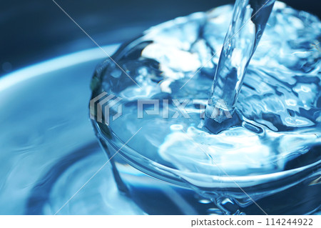 Water falling vigorously into a glass Water falling vigorously into a glass 114244922
