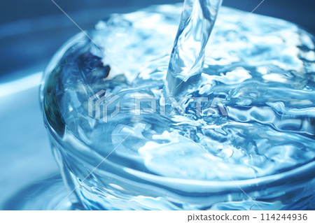 Water falling vigorously into a glass Water falling vigorously into a glass 114244936