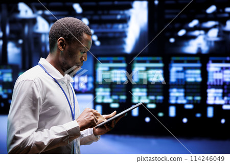 System administrator in server hub using renewable hydro energy sources to power cryptocurrency mining operations. Manager inspecting eco friendly supercomputers preventing environmental impact System administrator in server hub using renewable hydro energy sources to power cryptocurrency mining operations. Manager inspecting eco friendly supercomputers preventing environmental impact 114246049