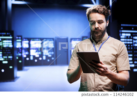 Manager in data center walking through server racks used for computationally intensive tasks such as quantum mechanics or weather forecasting. Specialist running annual equipment diagnosis 114246102