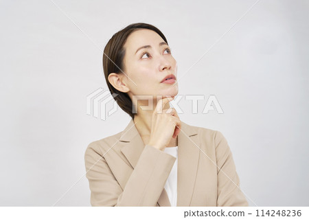 Thinking middle-aged business woman white background Thinking middle-aged business woman white background 114248236