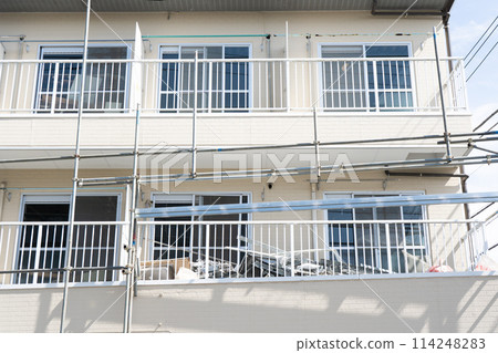Scaffolding is being set up during demolition work on a one-room apartment/condominium Scaffolding is being set up during demolition work on a one-room apartment/condominium 114248283