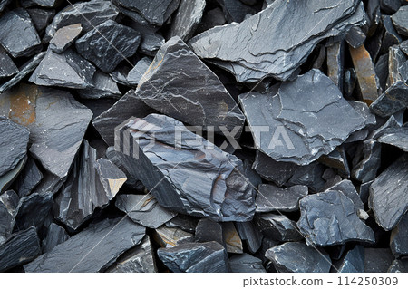 Detailed close up of textured slate stone chips in natural shades Detailed close up of textured slate stone chips in natural shades 114250309