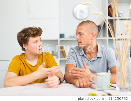 Sit-down conversation of dad and son 114250762