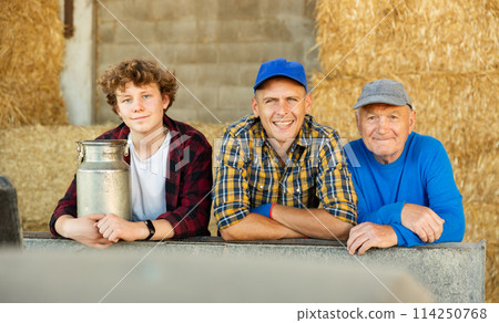 Portrait of farmers of different generations against background of hay bales. Concept of intergenerational continuity 114250768
