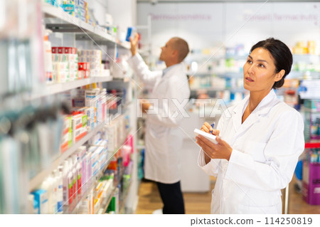 Pharmacist checking medicines in drugstore Pharmacist checking medicines in drugstore 114250819