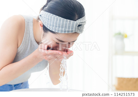 Beauty face wash woman washing her face with water 114251573