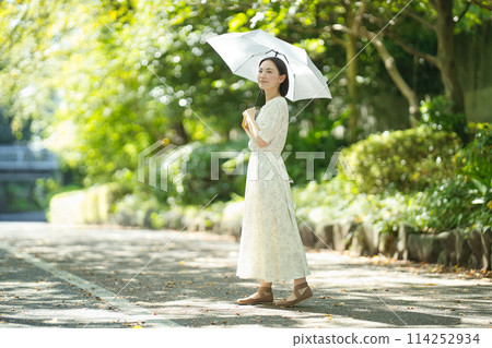 A young woman holding a parasol A young woman holding a parasol 114252934