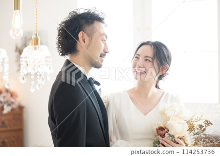 Image of a bride and groom gazing at each other at a wedding. For pre-wedding photos, bridal, weddings, etc. 114253736