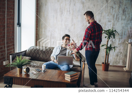 Romantic homo man presenting flowers to his beloved partner, Valentine's Day Romantic homo man presenting flowers to his beloved partner, Valentine's Day 114254344