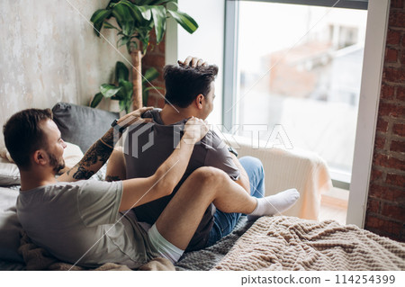 Two sexy caucasian gay guys hugging and having fun in bed indoors Two sexy caucasian gay guys hugging and having fun in bed indoors 114254399