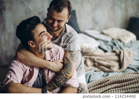 Two sexy caucasian gay guys hugging and having fun in bed indoors 114254400