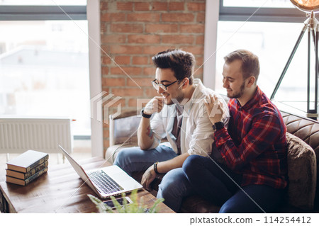 Homosexual partners working at office desk, relationships and business concept Homosexual partners working at office desk, relationships and business concept 114254412