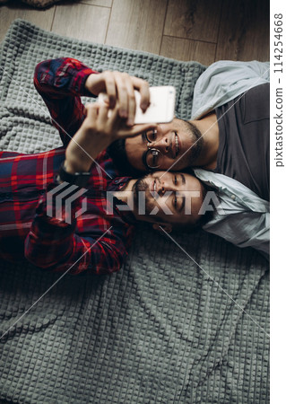 gay couple making selfie in bed 114254668